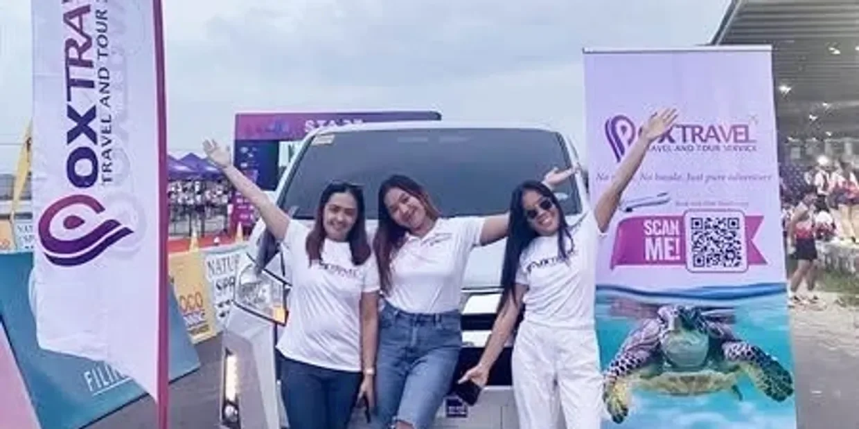 Three Pox Travel team members at the DAGSIK Preparation Run 2025 booth with the Pox Travel van and banners