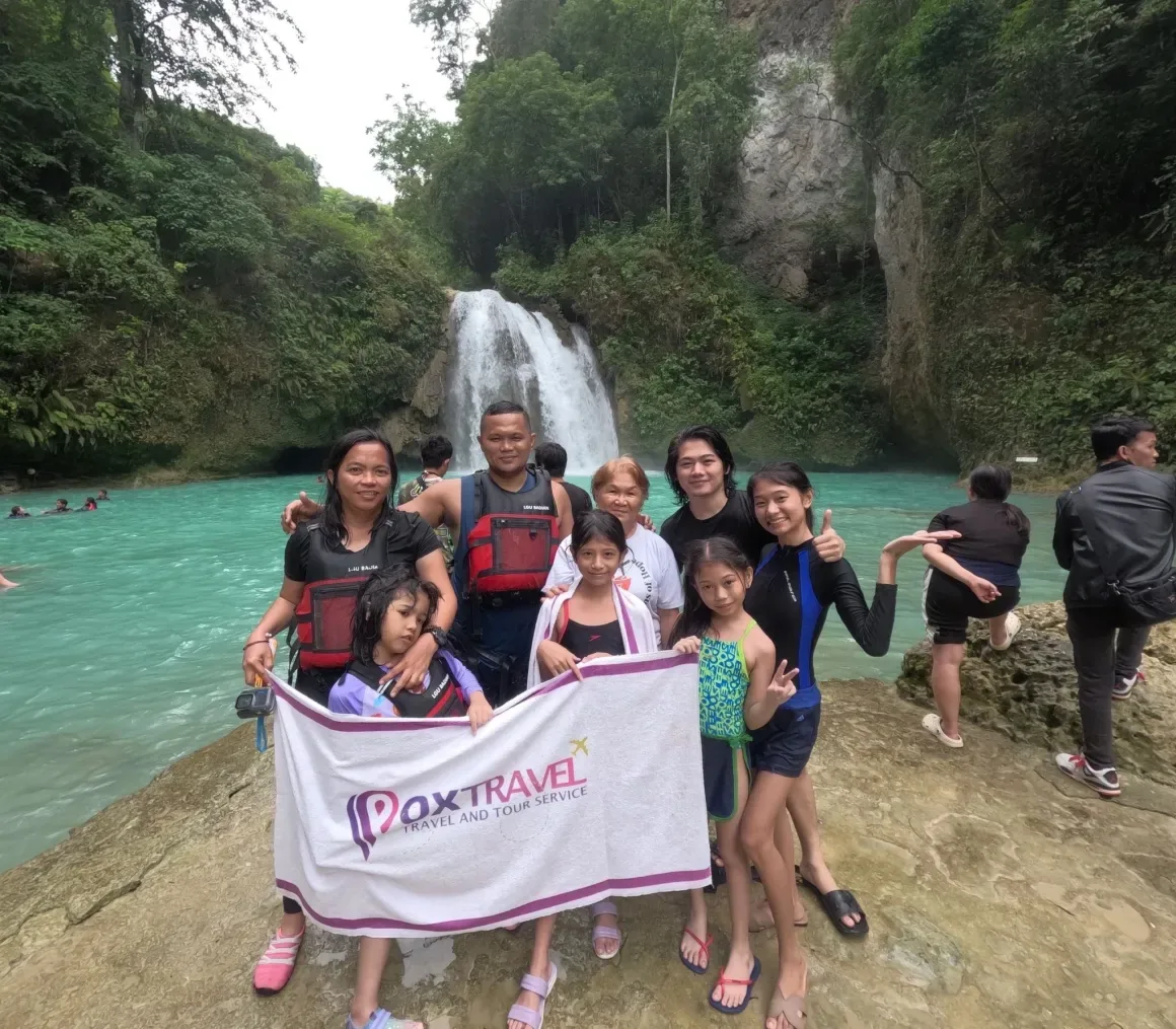 A family holding a Pox Travel towel at Kawasan Falls